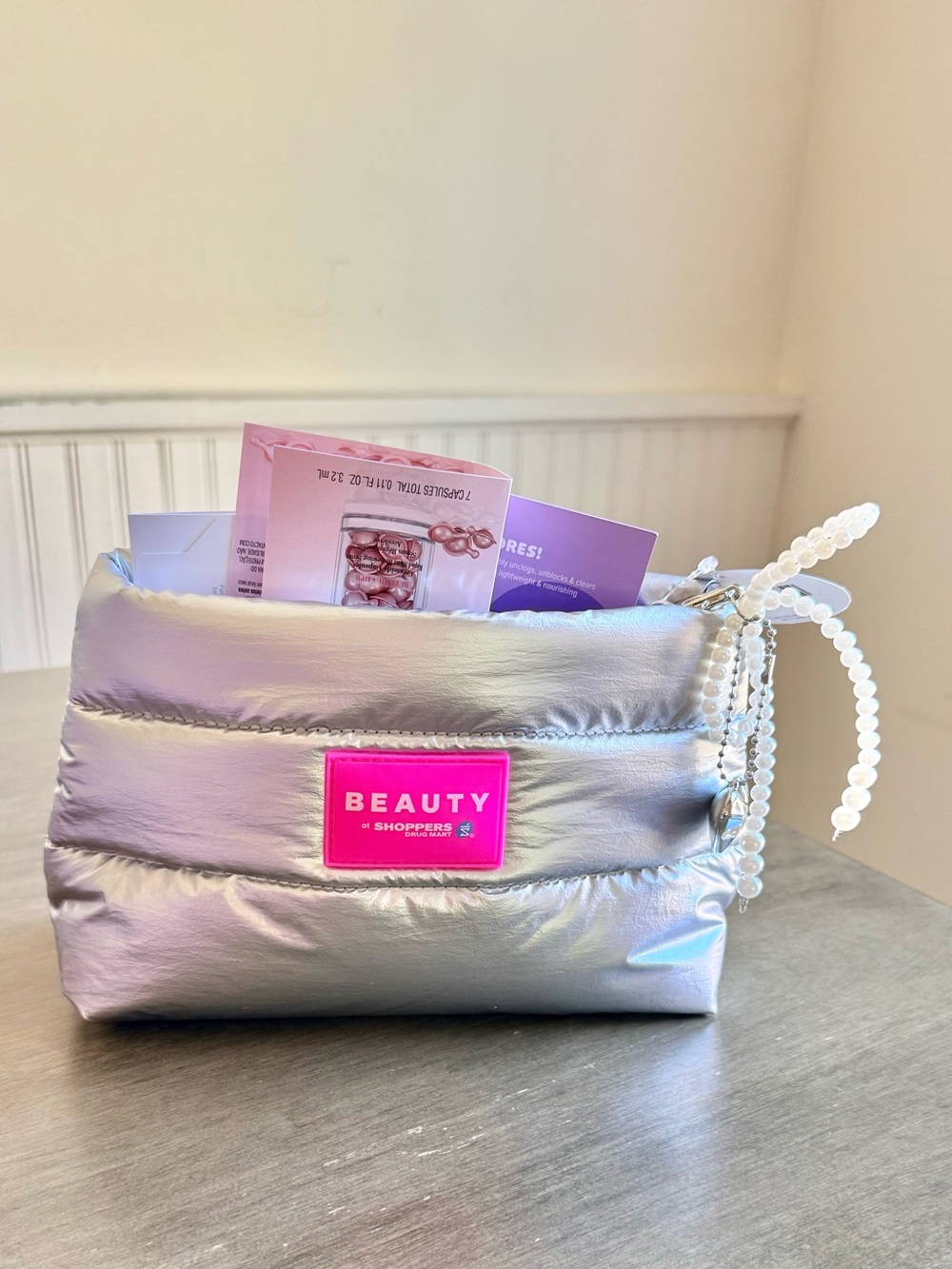 Beauty Iridescent Silver Puffer Cosmetic Bag with Skincare Samples